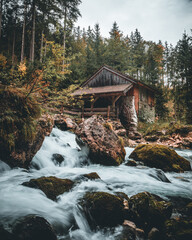 Historic mill at Golling Waterfall in Salzburg with flowing mountain stream © Maximilian