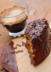 A moist carrot cake topped with a rich chocolate glaze, offering the perfect blend of sweet and savory flavors for a delightful dessert.