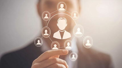 A businessman's finger hovers over a digital network of interconnected icons representing people.