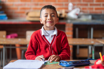 A Latino boy in uniform at school