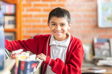 An elementary school student in the library looking for books