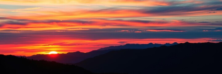 Fototapeta premium Vibrant colors of a sunset over majestic mountains, vibrant, colorful