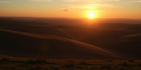 Fototapeta premium Sun setting over the rolling hills of the English countryside, casting a golden glow on the tranquil landscape, glow, tranquil