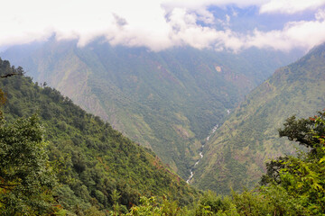 Naklejka premium Mountain streams running through the deep valleys of lowland Khumbu region near Paiya village on route to Base camp of Mera Peak,a 6476 meter high peak in the Khumbu Himalayas,Nepal