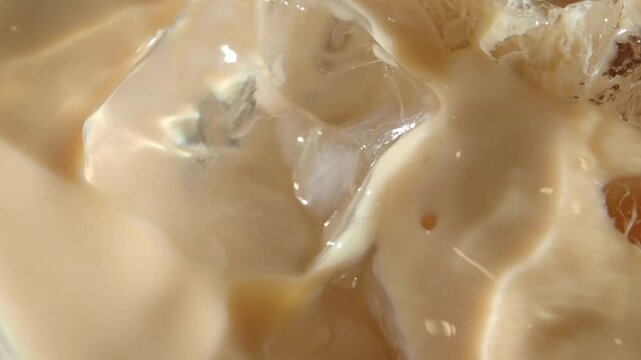 slow motion of falling ice cubes in a ice late coffee 