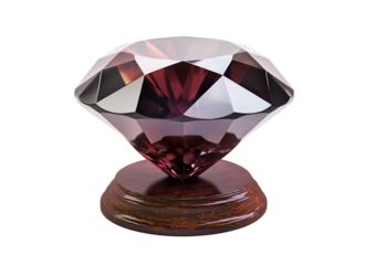 Large faceted gemstone on a wooden stand.