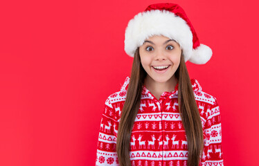 merry christmas. amazed teen girl in red christmas santa hat with copy space. santa christmas girl