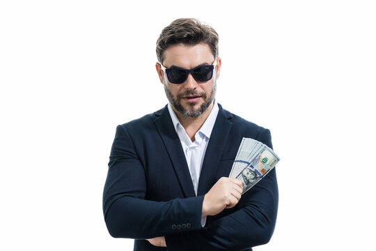 Business man hold money on white studio isolated background. Rich man in suit with money dollar bills. Successful businessman with dollar banknotes. Rich millionaire in suit holding money.