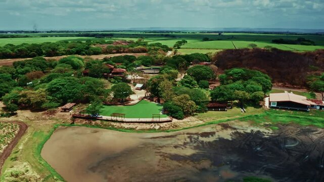 Aerial drone shot over la Hacienda el Viejo Wetlands in Guanacaste, Costa Rica. High view of the lush vegetation and the green landscape.