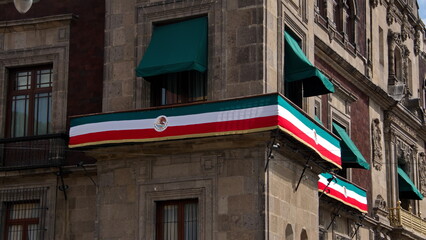 Banner in the colors of Mexico's flag on a building across from the Templo Mayor in Mexico City,...