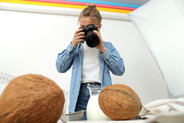 The girl is engaged in subject photography in a photo studio.