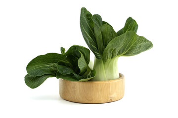 Fresh and crisp bok choy displayed in a wooden bowl isolated on white background