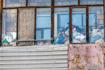 Cluttered balcony of an old apartment building on a winter day