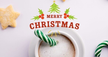Image of christmas greetings text over christmas decorations and candy cane with hot chocolate © vectorfusionart