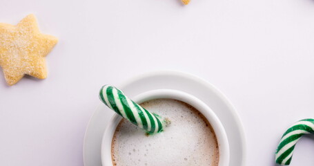 Image of christmas decorations and candy cane with hot chocolate