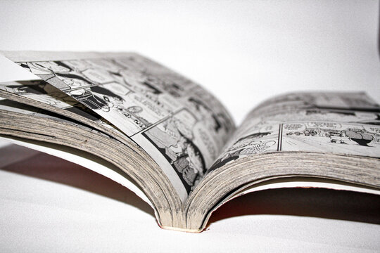 An open Detective Conan comic book on white background