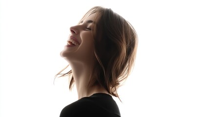 Fototapeta premium A joyful woman smiling against a bright background.