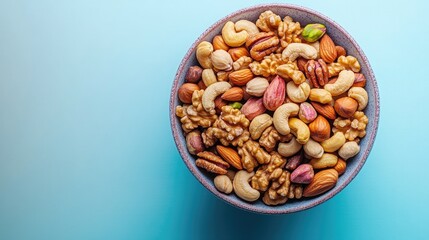 A bowl of assorted nuts on a blue background.