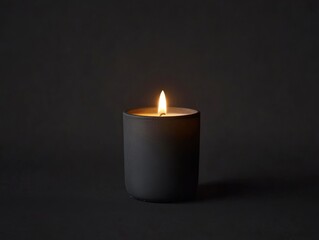 A single candle flame flickers softly in a dark setting, creating a warm ambiance.
