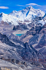 Vertical photo of stunning Mount Makalu,8485 m,5th highest mountain in the world with an azure blue glacial lake at its base viewed from Mera Peak,Nepal 