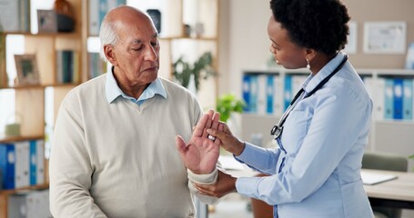 Obraz premium Doctor, senior patient and hand stretching for arthritis checkup, assessment and diagnosis at clinic. Woman, physiotherapist and male pensioner with wrist exercise for healthcare, help and support