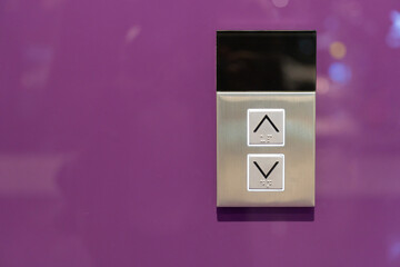 Elevator button on purple wall. Elevator Button up and down direction with copy space.