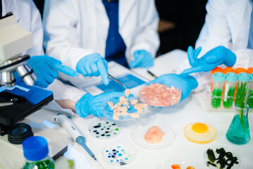 Team of scientists examining food samples in a lab with microscopes. Perfect for themes of food science, biotechnology,