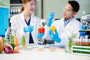 Team of scientists examining food samples in a lab with microscopes. Perfect for themes of food science, biotechnology,