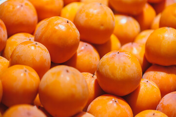 Fresh persimmon fruits selling at market