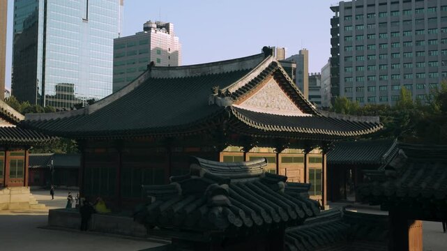 Deokhongjeon Hall With High-rise Buildings In The Background At Deoksugung Palace In Seoul, South Korea. - slider, reveal shot