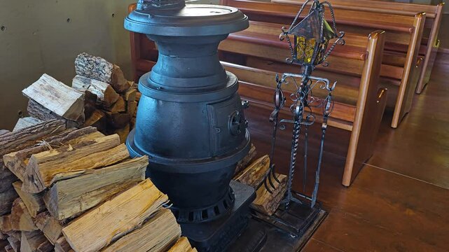 Close up of cast iron wood stove inside Silverbell Church, Pyeongchang County, South Korea, with pews in the background
