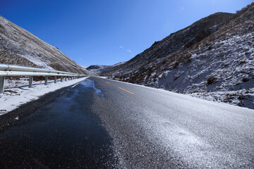 Empty road on snow mountain top