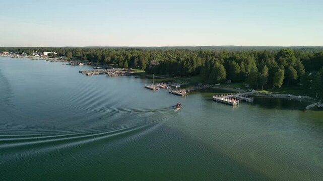 Aerial View of Chris Craft Antique Boat docking at summerhouse, Hessel, Michigan