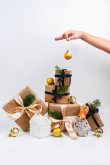 A women decorates a Christmas tree.  Space for text. winter holidays and people concept. Decorating Christmas tree, holding Christmas toy in a hand. Holiday, Christmas and New Year family celebration