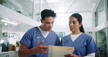 Team, nurse and folder with discussion for medical history, patient results or application at hospital. Man, woman or healthcare workers with documents or paperwork for health procedure at clinic