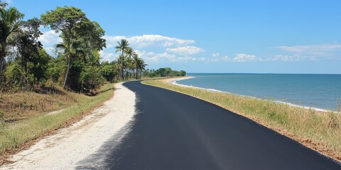 Serene Coastal Road with Lush Greenery and Calm Blue Waters Under a Clear Sky, Inviting Adventure and Exploration Along the Beautiful Shoreline Path