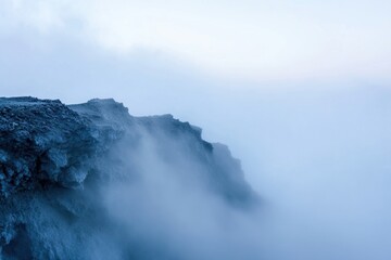 A misty cliff edge at dawn.