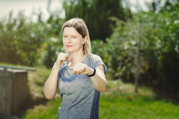 Young woman boxing in park, confident female fights back all problems