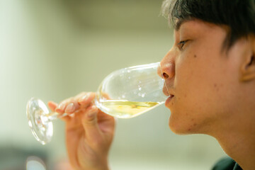 man hold glasses of champagne with lighting. Dinner party with drinking of champagne. hands holding clear glass with alcohol in yellow shine reflect.