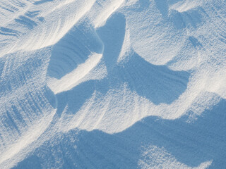 Snow texture. Wind sculpted patterns on snow surface. Wind in the tundra and in the mountains on...