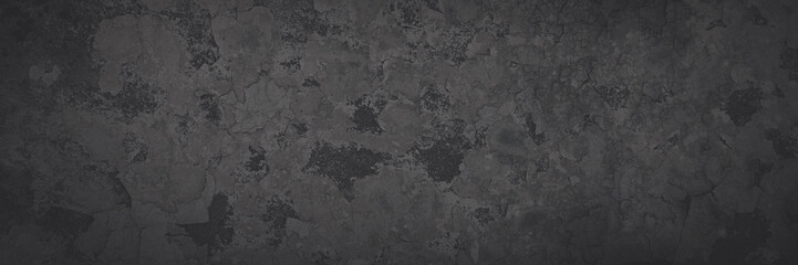 Dark wide panoramic background. Peeling paint on a concrete wall. Faded dark texture of old cracked...
