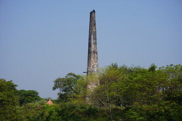 A brick kiln which is a furnace or oven specifically designed for baking or burning bricks inside the green forest