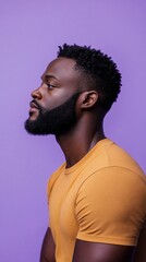 Obraz premium A man with a beard and dreadlocks is wearing a yellow shirt