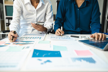 financial asian advisor showing plan of investment to clients in the consultancy office.