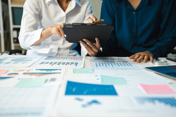 financial asian advisor showing plan of investment to clients in the consultancy office.