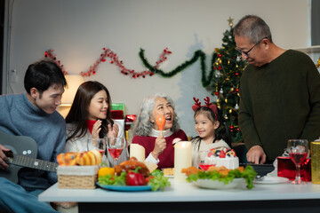 Dinner and Family holiday celebrating, together at Merry Christmas and  New Year. in a cozy festive home setting.