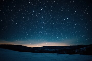 A starry night sky over snow-covered mountains.