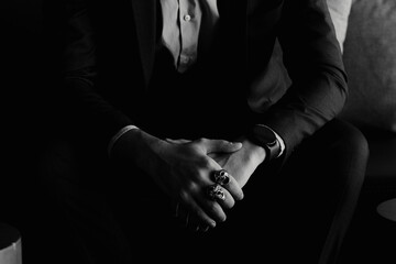 Stylish man in a suit with rings on his hands