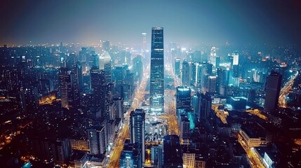 Obraz premium Nighttime Cityscape View of Urban Skyline with Skyscrapers and Busy Streets Illuminated by Bright Lights in a Modern Metropolis