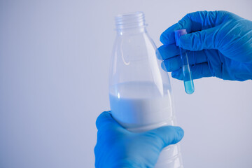 Expert work with milk, control quality in laboratory. Food test analysis, blue toning